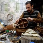Worker busy in making traditional musical instrument (Rabab) at his workplace in the Dabgari area.