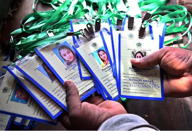 A worker displaying polling officials staff cards for General Election -2024 at DRO office
