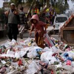 Gypsy girl collecting usable items from the garbage at Dalazak road