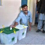 A disable person casts his vote in a polling station during General Election-2024