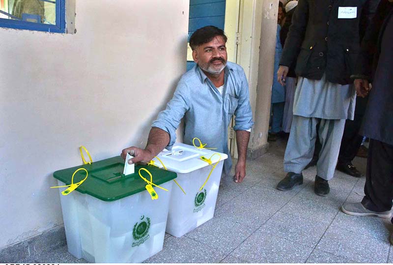 A disable person casts his vote in a polling station during General Election-2024