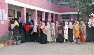 A disable person casts his vote in a polling station during General Election-2024