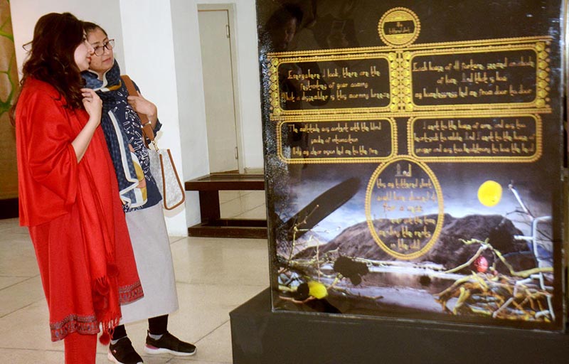 Women viewing artwork during Lahore Literature Festival at Al-Hamra