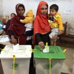 Women voters showing thumbs after casting their vote in polling station during General Election-2024