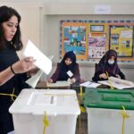 A female voter casting her vote in polling station during General Elections-2024