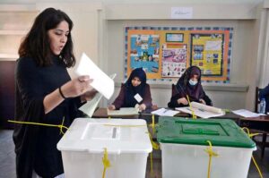 A female voter casting her vote in polling station during General Elections-2024
