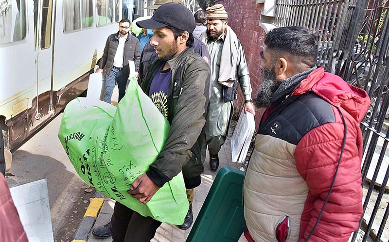 Polling staff on the way after receiving polling material at distribution Centre for General Elections 2024