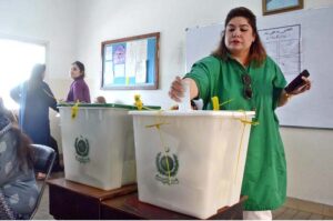 A female voter casting her vote in polling station during General Elections-2024