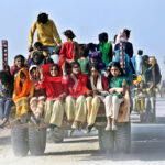 Girls on a tractor trolley on the way to attend a wedding function at New Gud Village Road.