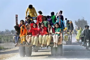  Girls on a tractor trolley on the way to attend a wedding function at New Gud Village Road. 