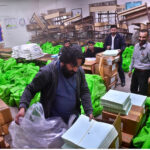 Workers packing bags with election materials, will be handed over to polling staff for upcoming February 08 General Election -2024, at Comprehensive School in North Nazimabad
