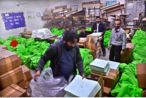 Workers packing bags with election materials, will be handed over to polling staff for upcoming February 08 General Election -2024, at Comprehensive School in North Nazimabad