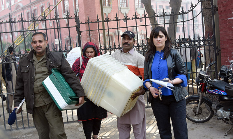 Polling staff on the way after receiving polling material at distribution Centre for General Elections 2024