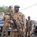 Army personnel standing alert on the eve of General Elections 2024 at Korangi Girls College