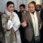 Former Prime Minister and PML-N leader Nawaz Sharif gives his thumb impression on a ballot paper to cast his vote at polling station during General Election-2024