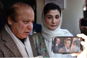 Former Prime Minister and PML-N leader Nawaz Sharif gives his thumb impression on a ballot paper to cast his vote at polling station during General Election-2024