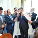 Members of the Royal Foundation of Gilgit-Baltistan present a cultural robe as a souvenir to caretaker Prime Minister Anwaar-ul-Haq Kakar.