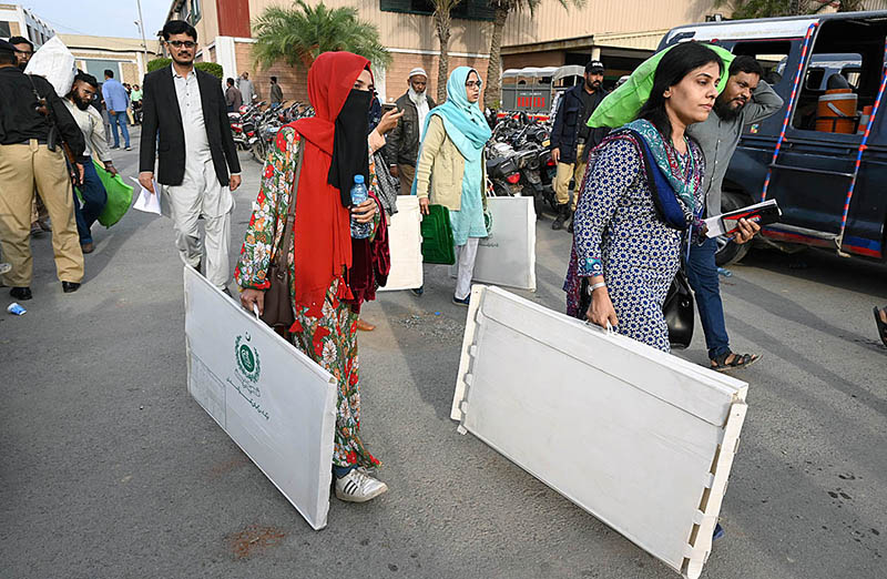 Election presiding officers on their way after collecting ballot materials at a distribution center at Expo Center a day prior Pakistan’s General Elections-2024.