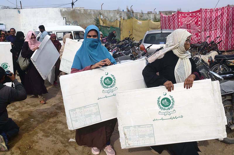 Presiding officers receiving ballot material on the eve of General Elections 2024 at Korangi Girls College.