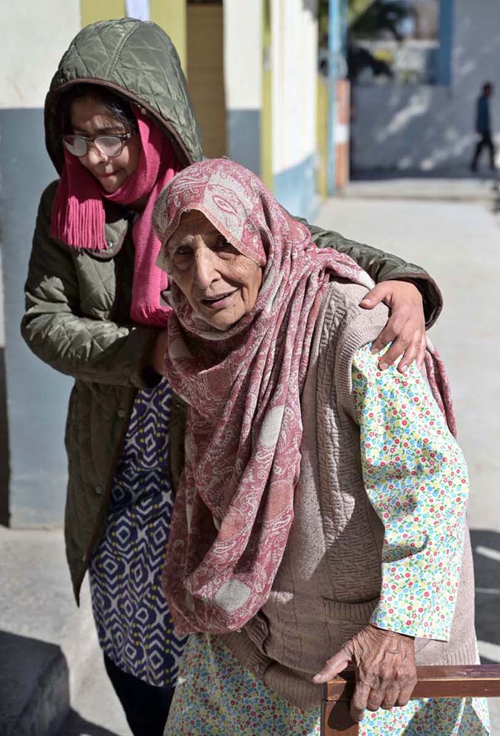 An elderly woman coming at polling station to cast her vote during General Election-2024