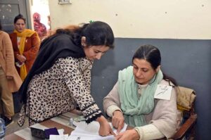 Women standing in queue waiting for their turn to cast their vote at polling station during General Election-2024.