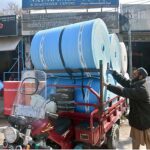 A labourer loading foamic sheets on loader rickshaw at Said Pur Road.