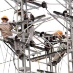WAPDA workers busy in installing new electricity cables on pylons at Tarlai.