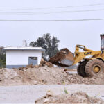 Labourer busy in construction work of Bridge with the help of heavy machinery at I-9 during development work in the city