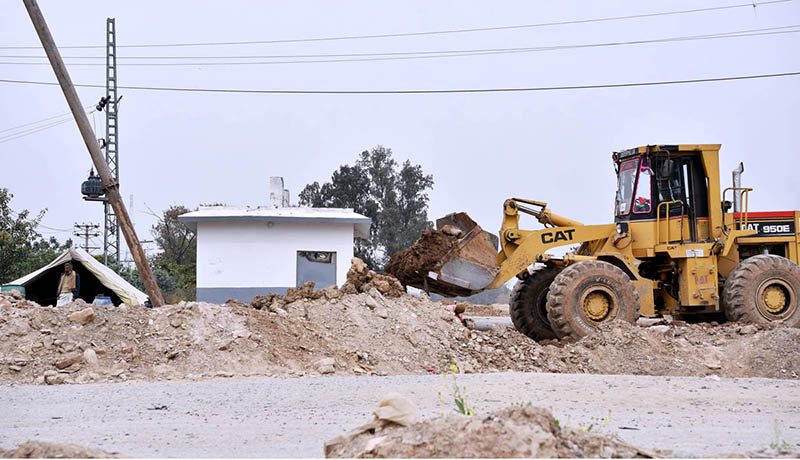 Labourer busy in construction work of Bridge with the help of heavy machinery at I-9 during development work in the city