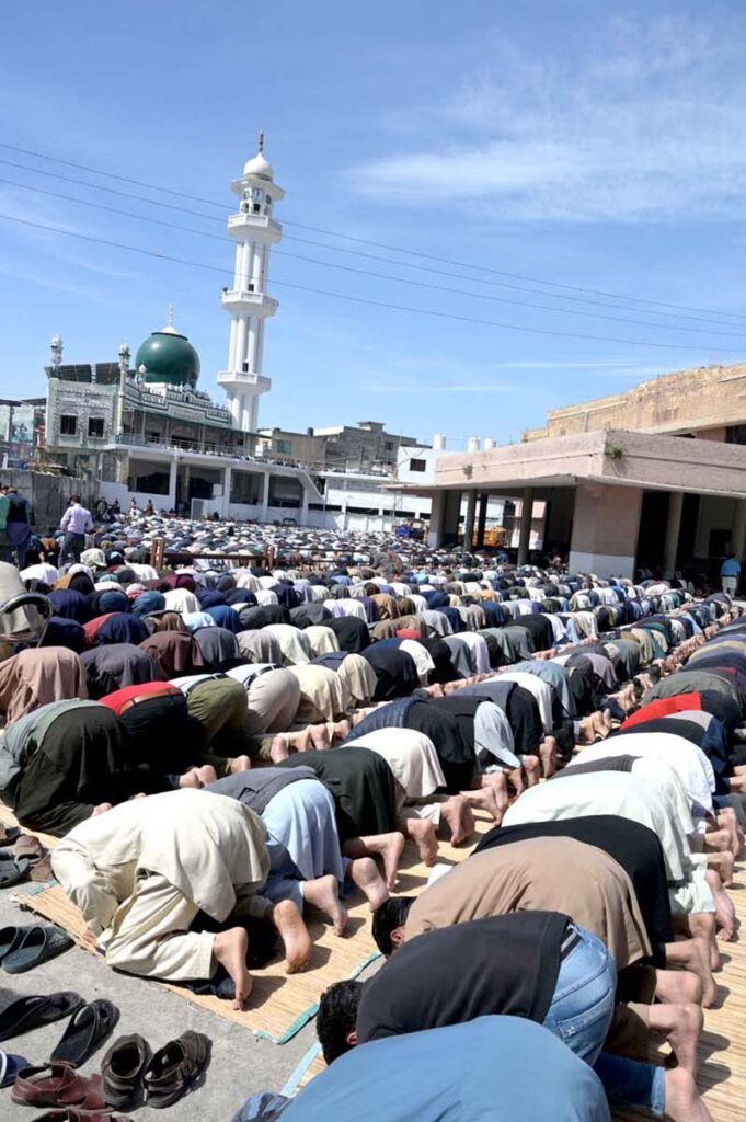 People perform the first Friday prayer at a mosque during the holy month of Ramadan at Saddar.