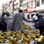 A vendor selling banana at his roadside setup