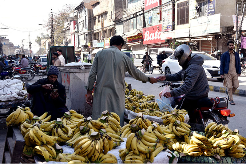 A vendor selling banana at his roadside setup
