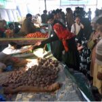 People purchasing vegetables from Ramadan Bazar on subsidized rates near Shamsabad