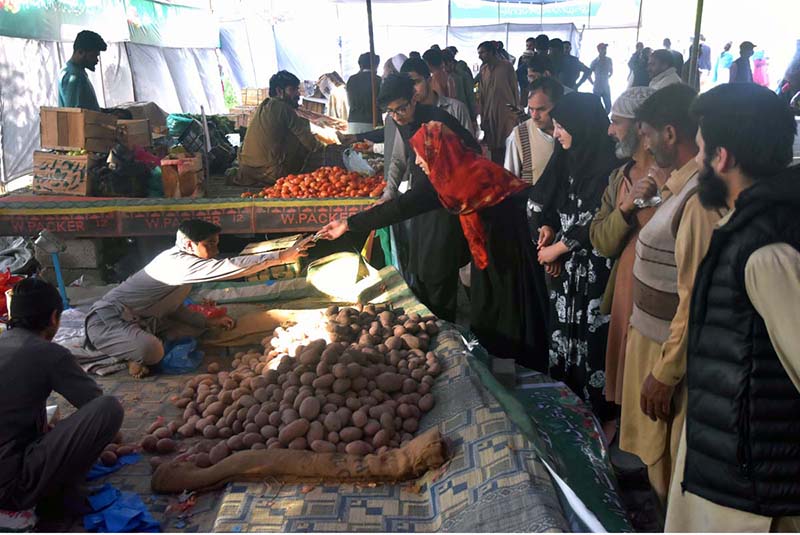 People purchasing vegetables from Ramadan Bazar on subsidized rates near Shamsabad
