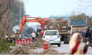 Labourers working on Chak Shahzad Road expansion in the Federal Capital.