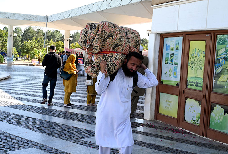 People arriving with their luggage for Itikaf at Faisal Masjid.