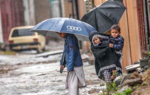 Motorcyclists and vehicles on their way at Islamabad Expressway during rain that experienced the Federal Capital