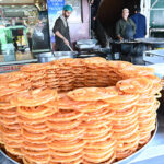 A vendor prepares sweet food item Jalebi at his roadside setup in Karachi Company Market