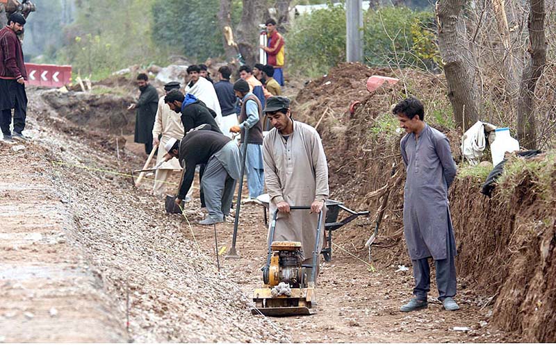 Labourers working on Chak Shahzad Road expansion in the Federal Capital.