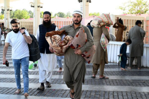 People arriving with their luggage for Itikaf at Faisal Masjid.
