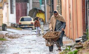 Motorcyclists and vehicles on their way at Islamabad Expressway during rain that experienced the Federal Capital