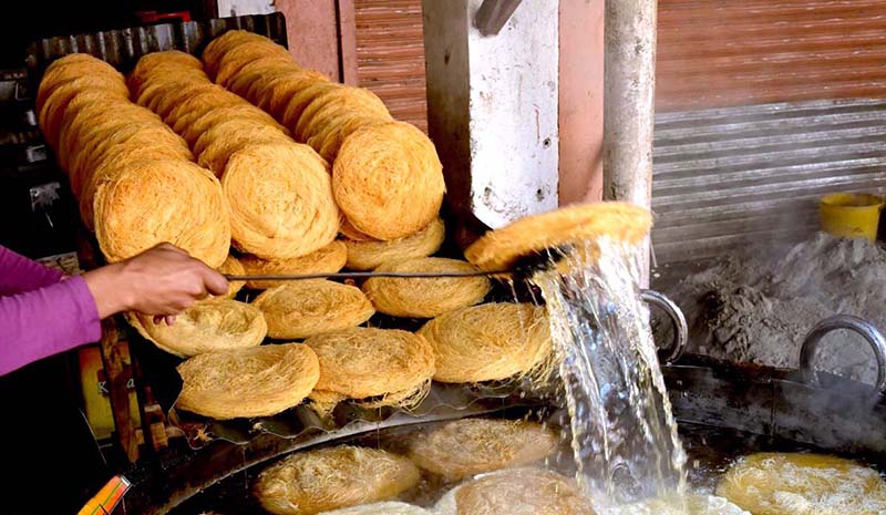 A vendor preparing traditional food item Pheoni in connection with upcoming Holy Fasting Month of Ramadan at Banni Chowk