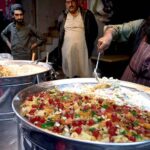 A vendor displaying and selling traditional Fruit chaat to attract customers for iftaar during Holy fasting Month of Ramadan at Kartarpura