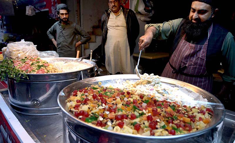 A vendor displaying and selling traditional Fruit chaat to attract customers for iftaar during Holy fasting Month of Ramadan at Kartarpura