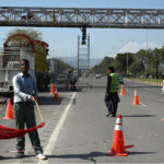 Painters busy coloring a pedestrian bridge at Expressway