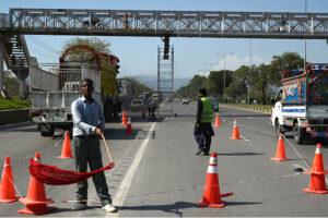 Painters busy coloring a pedestrian bridge at Expressway