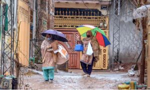 Motorcyclists and vehicles on their way at Islamabad Expressway during rain that experienced the Federal Capital