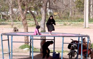 Children enjoy swing in a local park at Kuri Road