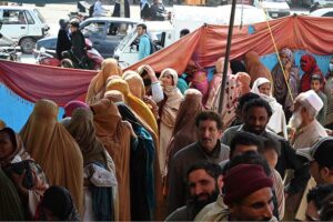 A person carrying flour bags provided by the Government on subsidized rate.