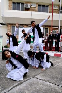 School Student volunteers performing on the occasion of Flag Hoisting in the presence of Secretary General PRCS, Abaid Ullah Khan, Representatives from Humanitarian organisations, Civil Society, Lawyers, Teachers and others -Staff of PRCS, IFRC, ICRC, Norwegian Red Cross, Turkish Red Crescent, German Red Cross and Volunteers at Pakistan Red Crescent Society, National Headquarters.